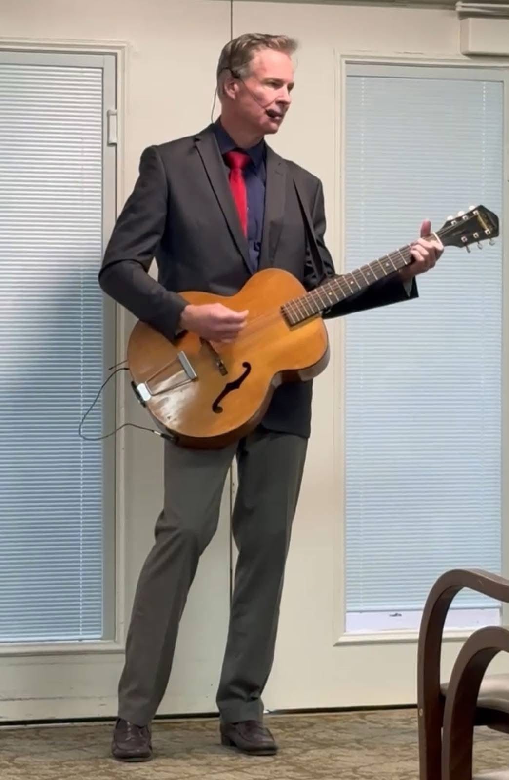 Matt singing and playing his archtop guitar